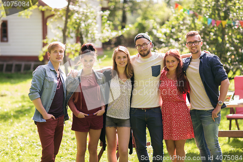 Image of happy teenage friends hugging at summer garden