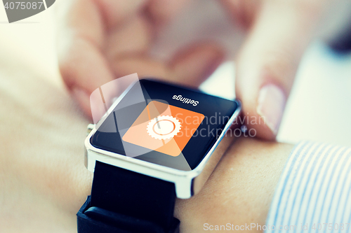 Image of close up of hands setting smartwatch