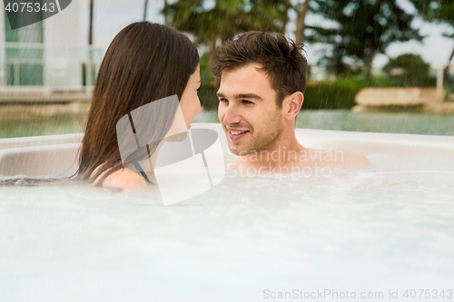 Image of Young couple in a jacuzzi