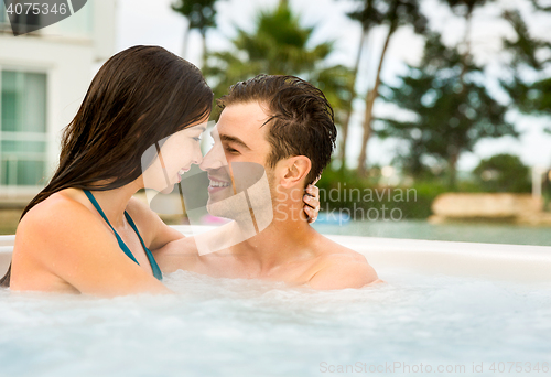 Image of Young couple in a jacuzzi