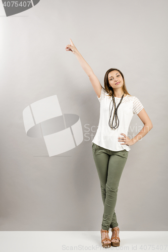 Image of Woman pointing to the wall