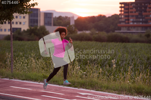 Image of a young African American woman jogging outdoors