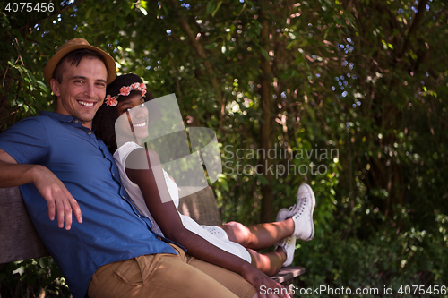 Image of Young multiethnic couple having a bike ride in nature