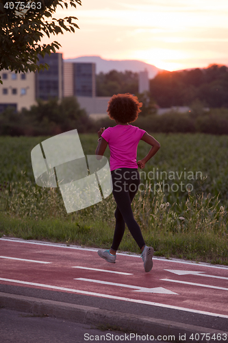 Image of a young African American woman jogging outdoors