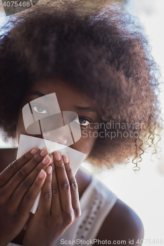 Image of a young African American woman eating pasta