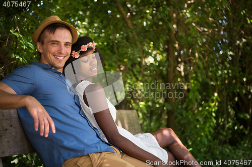 Image of Young multiethnic couple having a bike ride in nature