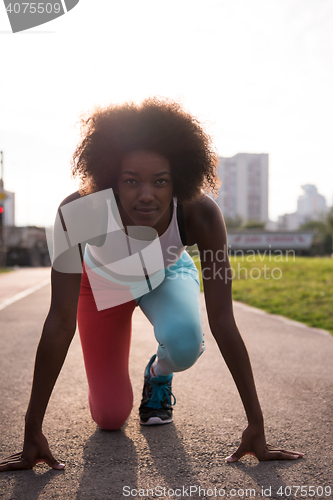 Image of Portrait of sporty young african american woman running outdoors