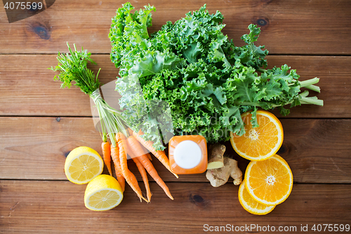 Image of bottle with carrot juice, fruits and vegetables