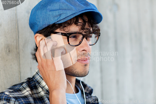 Image of close up of man with earphones listening to music