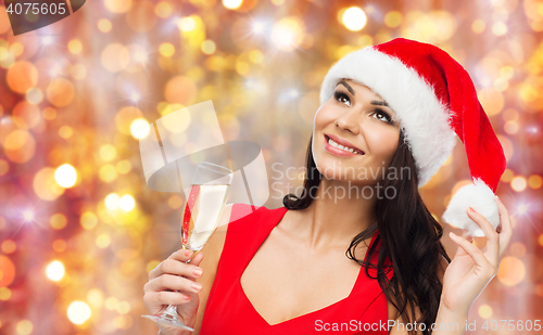 Image of beautiful sexy woman in santa hat and red dress