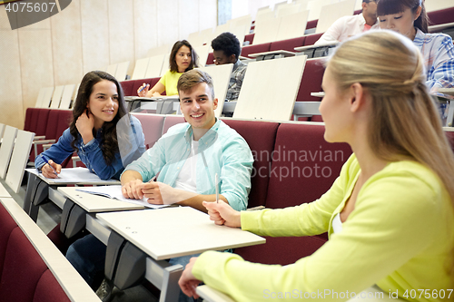 Image of group of students with notebooks at lecture hall