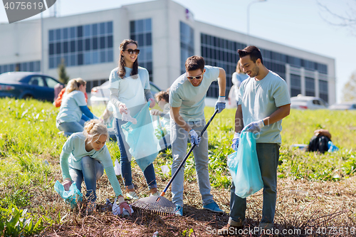 Image of volunteers with garbage bags cleaning park area