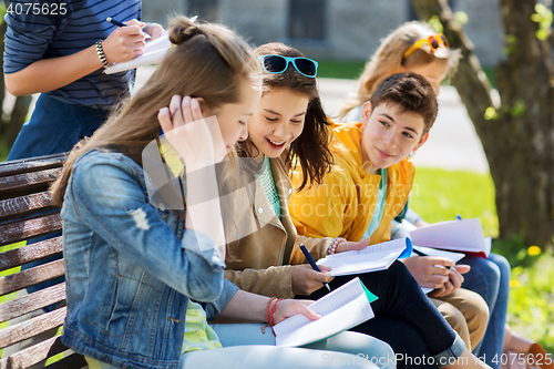 Image of group of students with notebooks at school yard