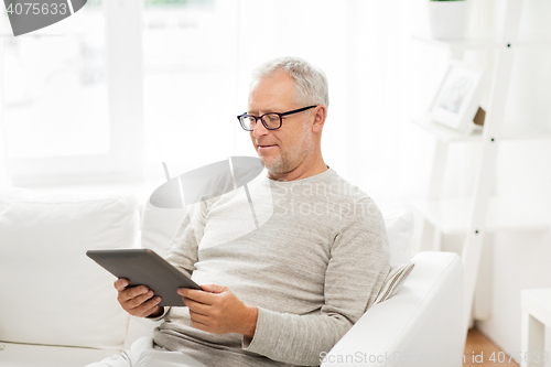 Image of senior man with tablet pc at home