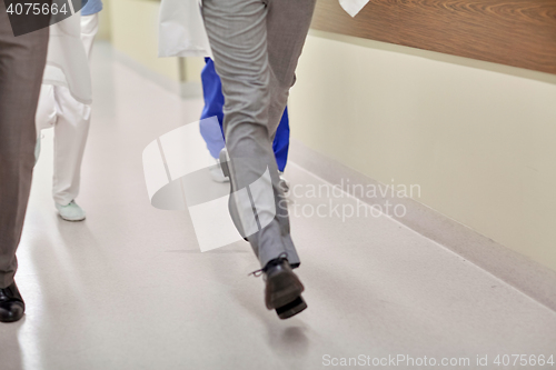 Image of close up of medics or doctors running at hospital