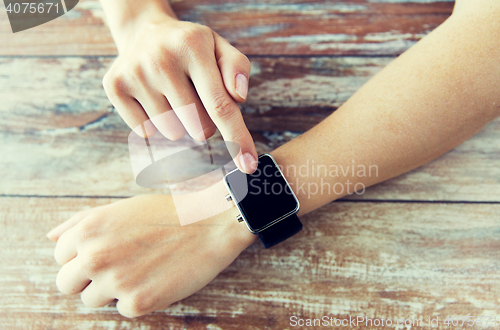 Image of close up of hands setting smart watch