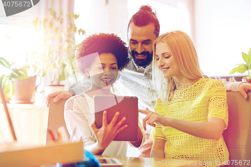 Image of happy creative team with tablet pc in office