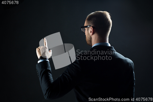 Image of businessman pointing finger to something invisible