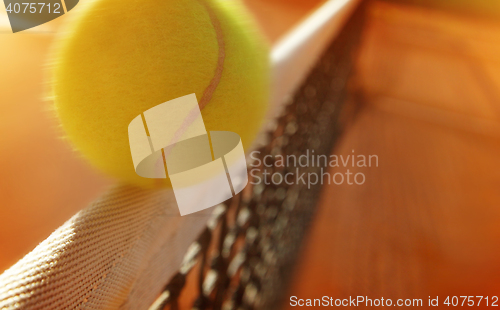 Image of Tennis ball hitting the net