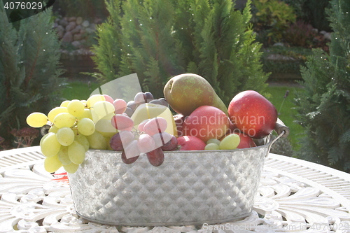 Image of Different kind of fruits on table in the garden