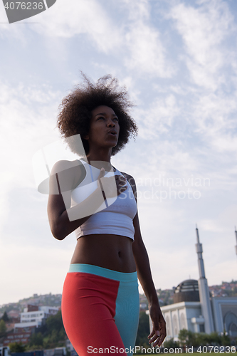 Image of Portrait of sporty young african american woman running outdoors