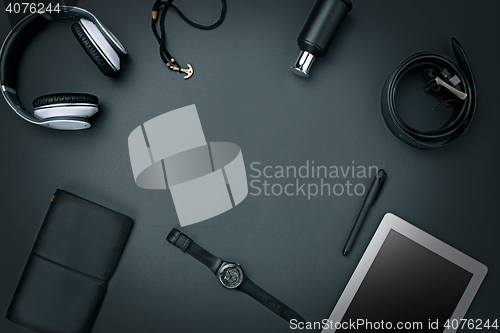 Image of Workplace of business. Modern male accessories and laptop on black background