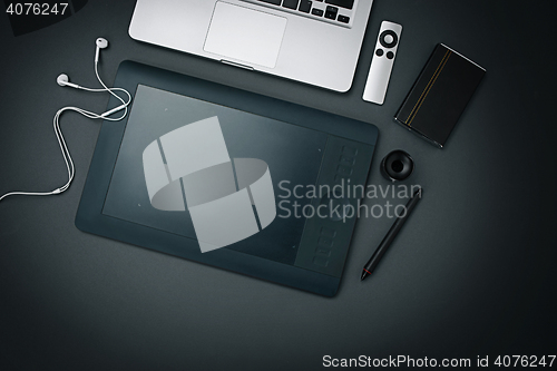 Image of Workplace of business. Modern male accessories and laptop on black background