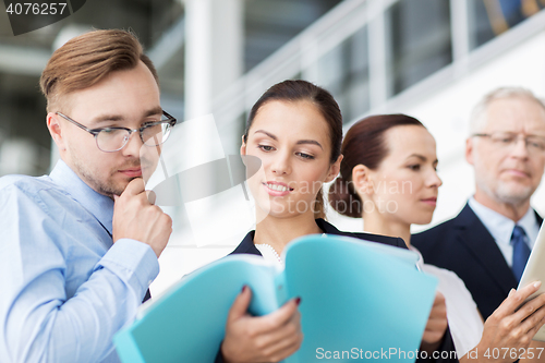 Image of business team with folders meeting at office