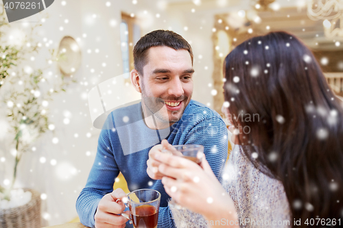 Image of happy couple drinking tea at cafe