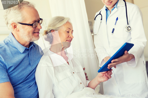 Image of senior woman and doctor with tablet pc at hospital