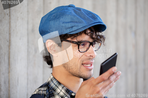 Image of man recording voice or calling on smartphone