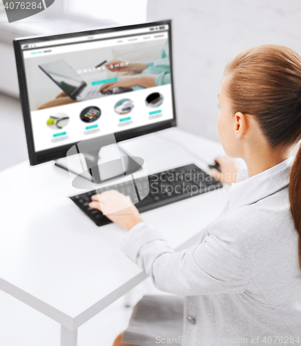 Image of businesswoman with online shop on office computer