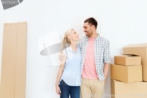 Image of couple with cardboard boxes moving to new home