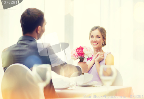 Image of smiling woman recieving bouquet of flowers