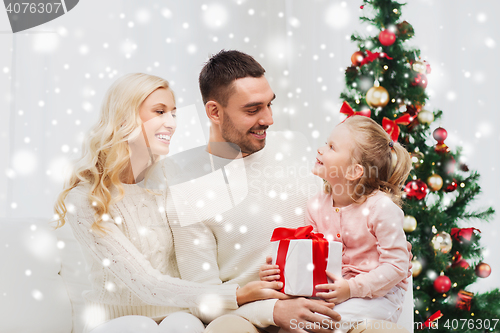 Image of happy family at home with christmas tree