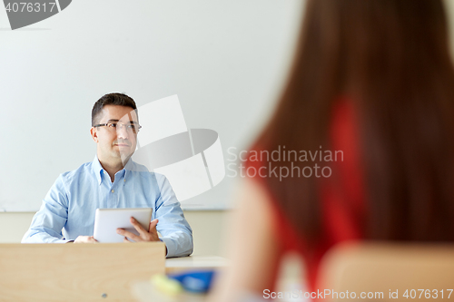 Image of students and teacher with tablet pc at school