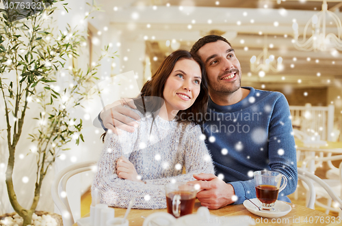 Image of happy couple drinking tea at restaurant