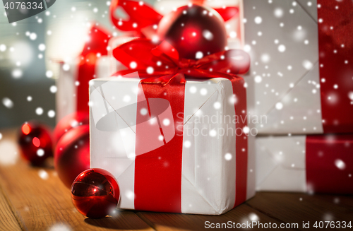 Image of close up of gift boxes and red christmas balls