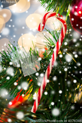 Image of close up of sugar cane candy on christmas tree