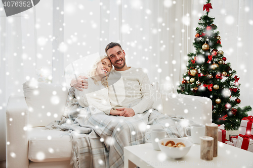 Image of happy couple at home with christmas tree