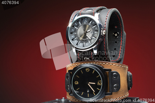 Image of two men\'s watches with wide leather bracelet 