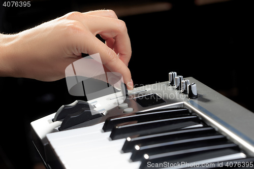 Image of Girl\'s hands on the keyboard of the piano