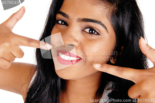 Image of Woman pointing at her white teeth.