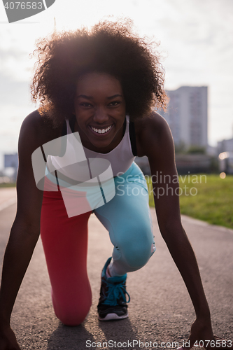 Image of Portrait of sporty young african american woman running outdoors