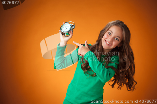 Image of The cute cheerful little girl on orange background