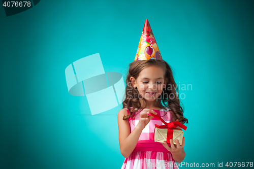 Image of The cute cheerful little girl on blue background