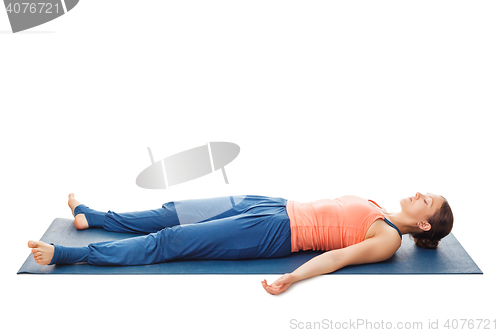 Image of Women relaxes in yoga asana Savasana