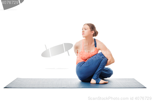 Image of Woman doing Ashtanga Vinyasa Yoga asana Marichyasana D