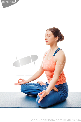 Image of Woman meditating in yoga asana Padmasana Lotus pose