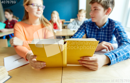 Image of high school students reading book and learning